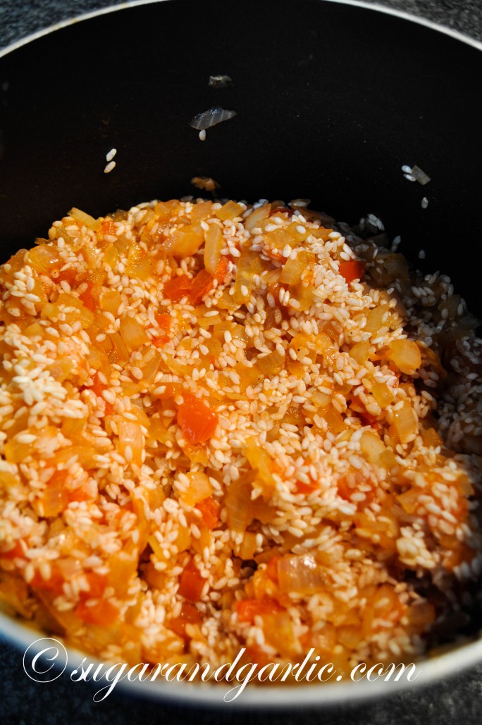 Stir in the rice and tomato paste.