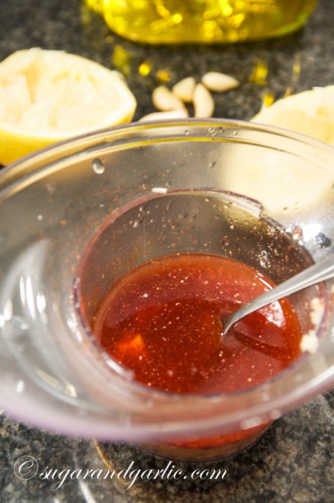 Mix lemon juice, salt, pepper, paprika, sumac, crushed garlic, and olive oil to dress the chicken.
